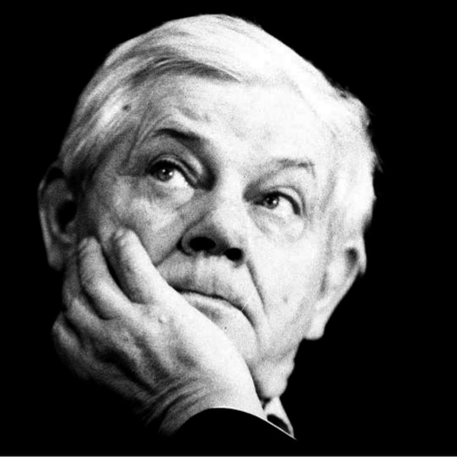 black white head shot of the poet, he is looking upwards to the left and his chin is resting in his hand