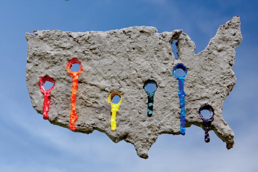 an abstract concrete like shape on a sky background, there are six holes each one drips coloured paint,red, orange, yellow, green, blue, and violet.