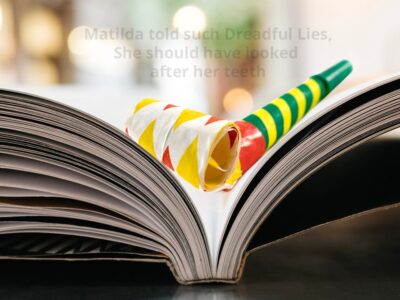 An open book with a colourful party blower resting on the pages. The words "Matilda told such Dreadful Lies, She should have looked after her teeth" are just about visible above it.