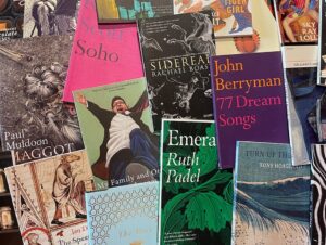 Photograph showing various poetry book and pamphlet covers, all brightly coloured, or with interesting attractive designs.