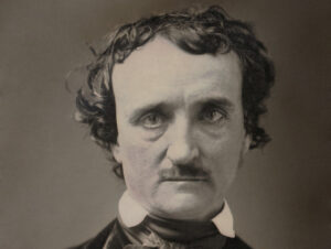 Black and white photograph of Edgar Allan Poe. He looks intently at the camera.
