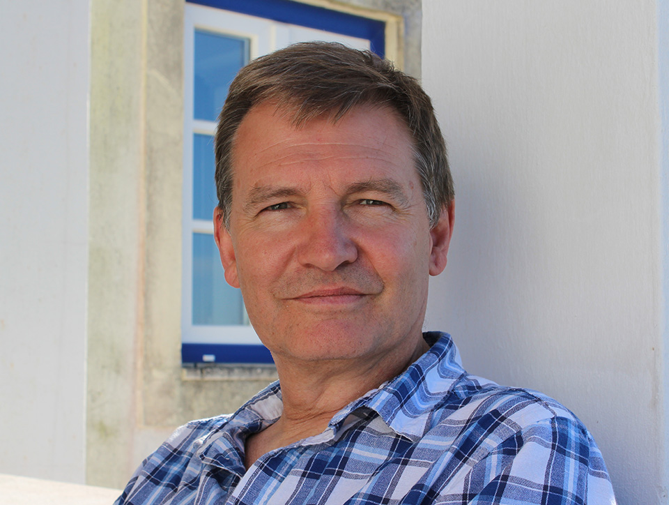 Martyn Crucefix looking at the camera. He has short brownish hair and a blue check shirt.