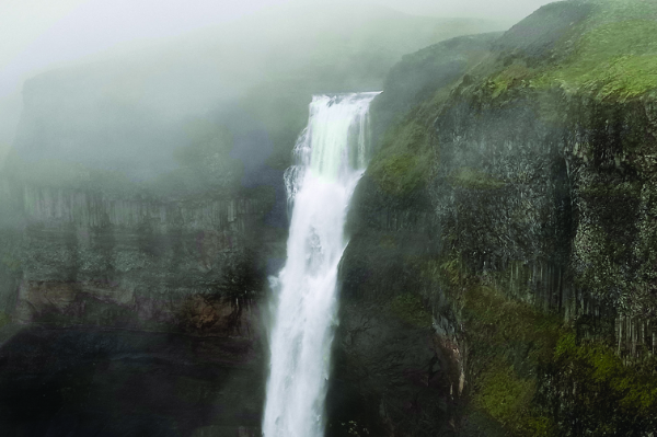 A waterfall on a foggy mountainside. It's high, and the middle of ... well, you get it.