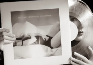 A photograph of Taylor Swift taking a vinyl disc from its sleeve. the album is hers, the cover shows the normal rock'n'roll stuff, you know, woman in underwear lying on a bed etc.